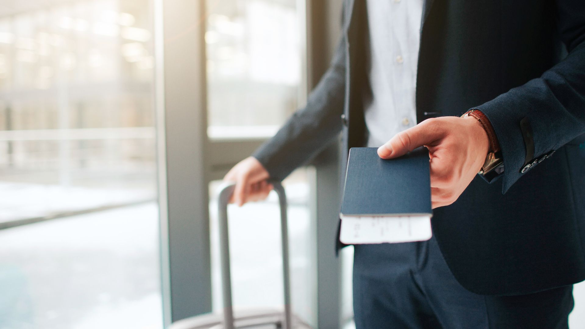Business traveler holding passport at international airport symbolizing fast second citizenship